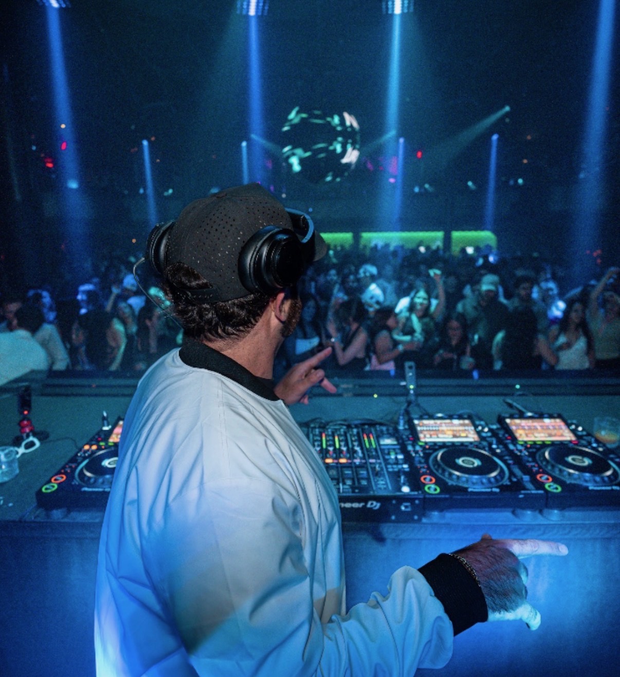 Negus DJing a club set under a disco ball