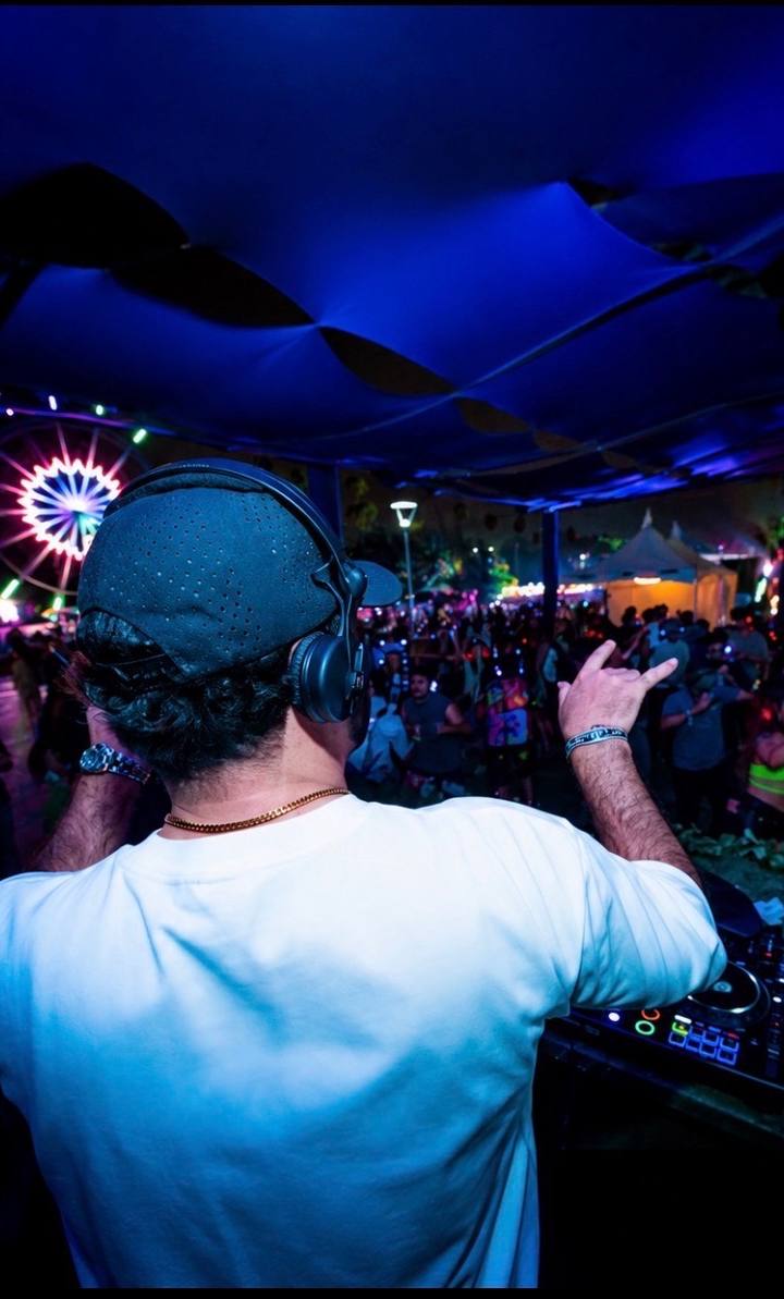 Negus performing under a branded stage screen